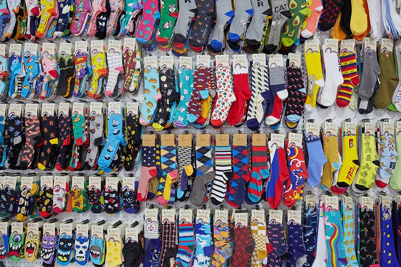 Custom sock supplier reviewing samples materials logos and packaging