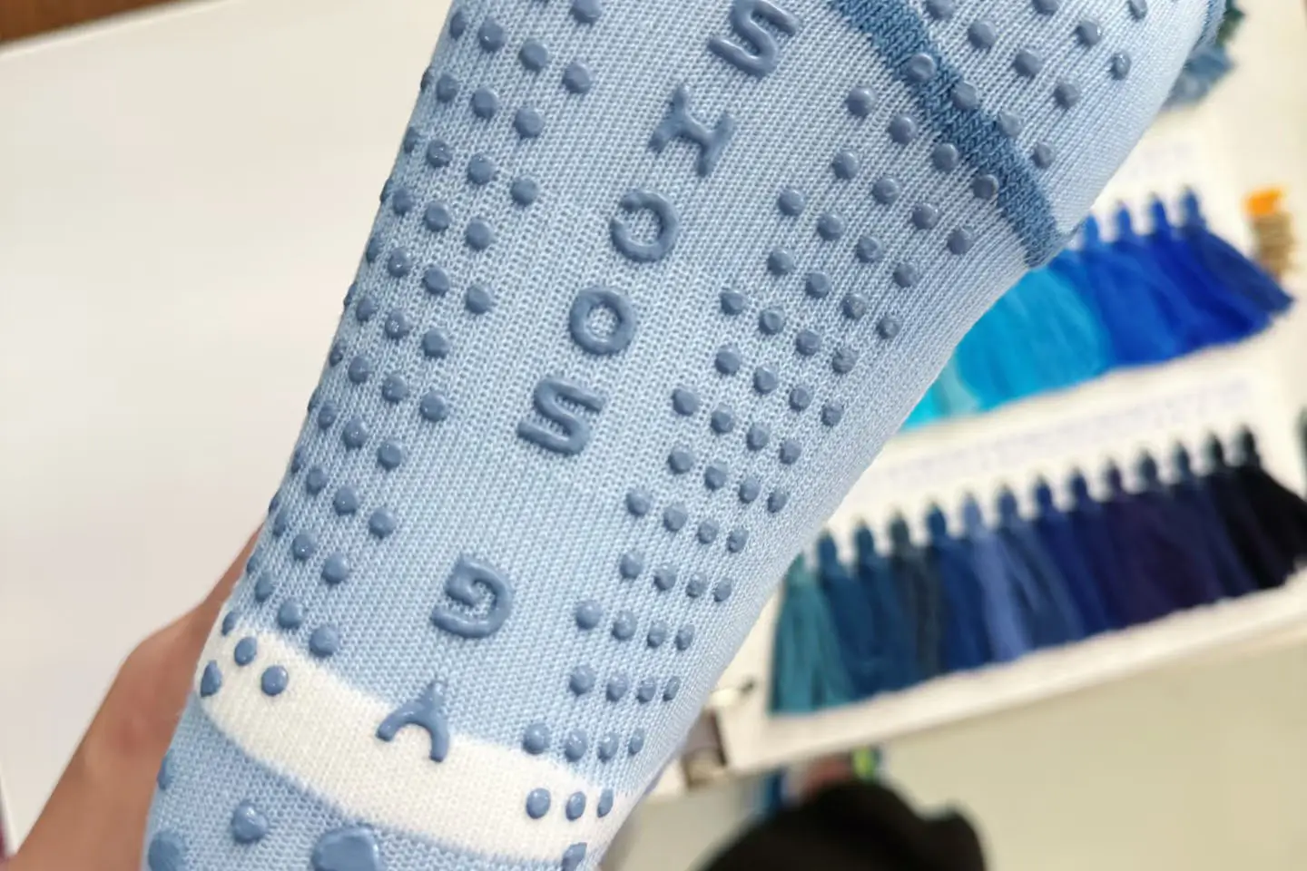 Custom grip sock sole design with silicone dots and logo layout