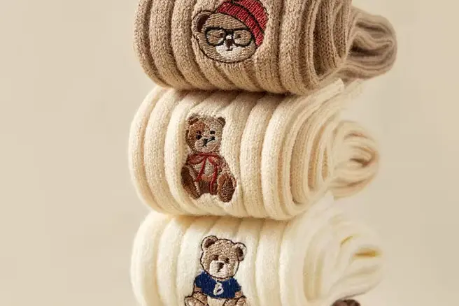 Embroidered crew socks with small logo detail on the cuff or side