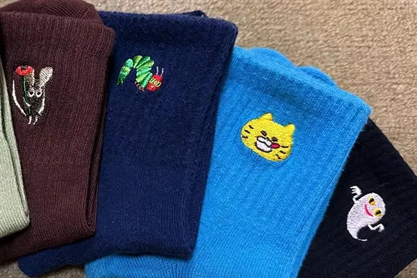Embroidered logo detail on premium custom socks