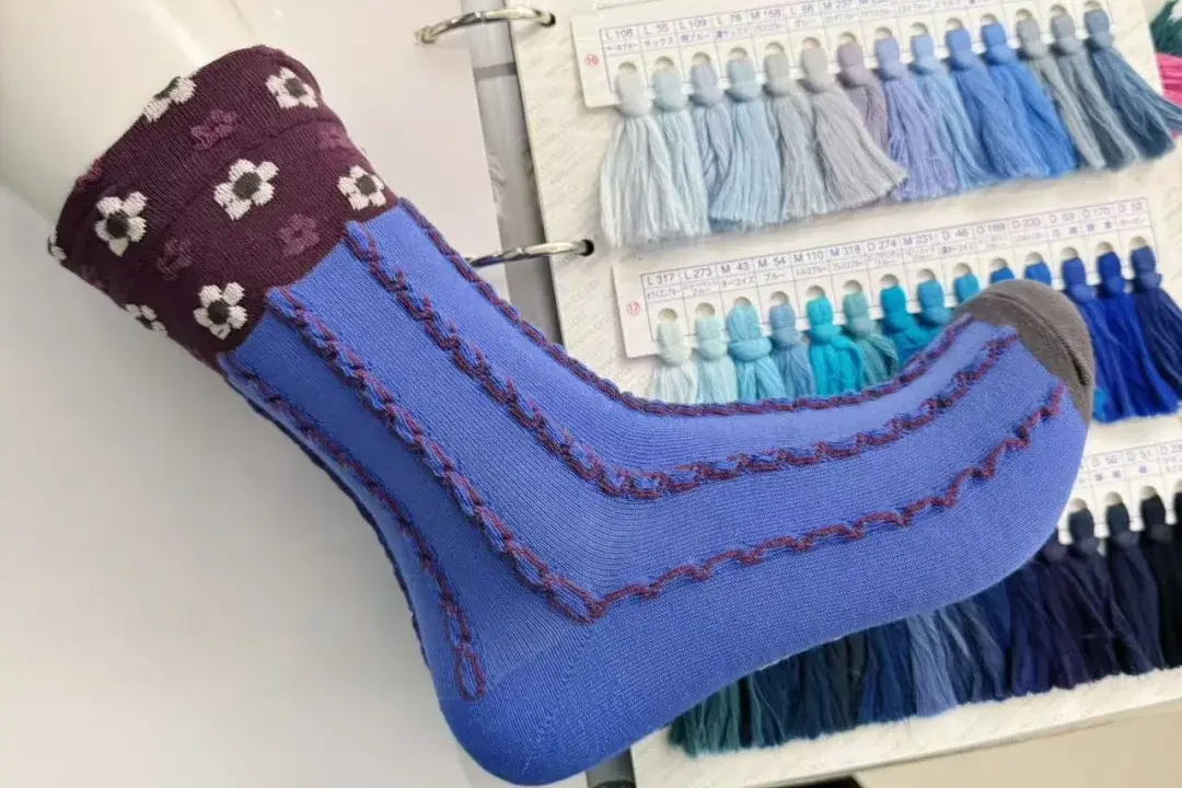 Reviewing a custom sock sample before bulk production