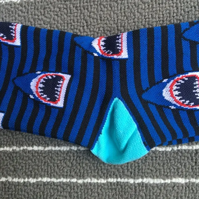 Over-calf compression-style socks with elastic material and size planning